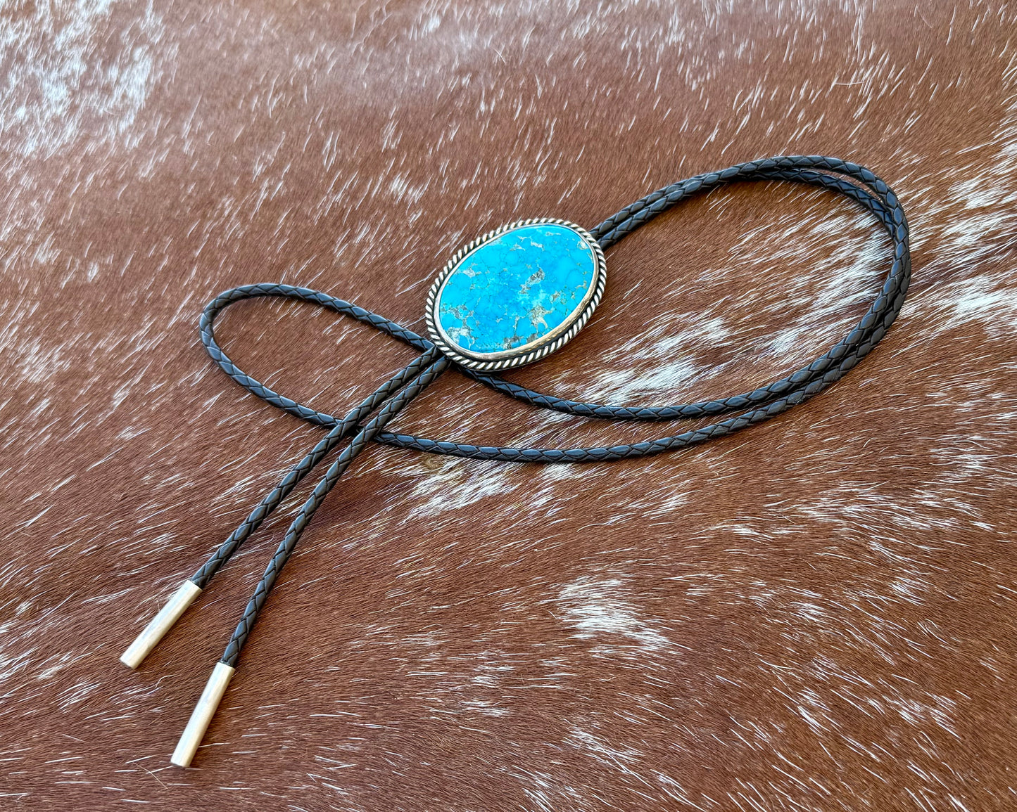 Bright Blue Kingman Turquoise Bolo Tie with dark brown leather cord and sterling silver tips