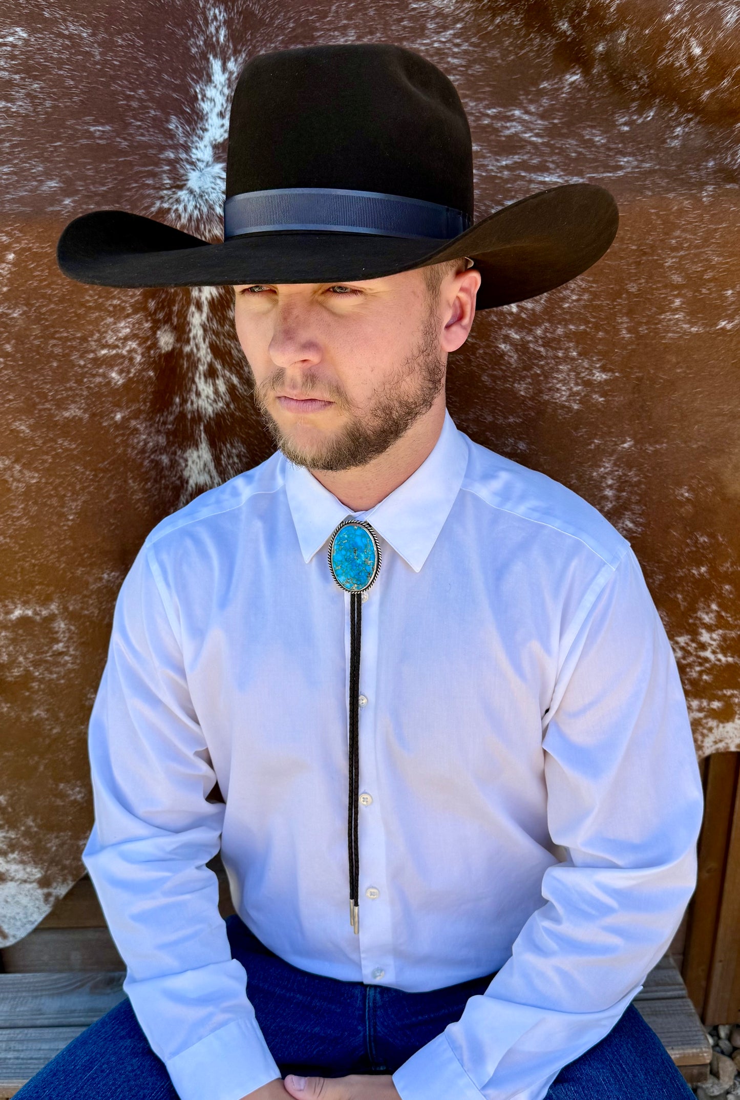 Bright Blue Kingman Turquoise Bolo Tie with dark brown leather cord and sterling silver tips