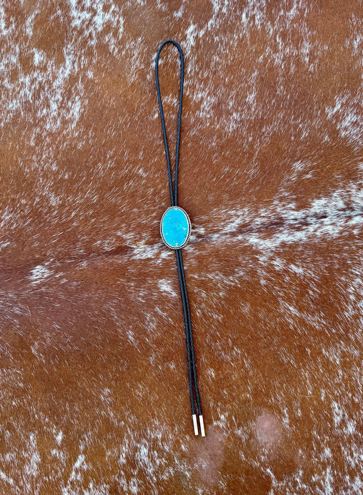 Bright Blue Kingman Turquoise Bolo Tie with dark brown leather cord and sterling silver tips