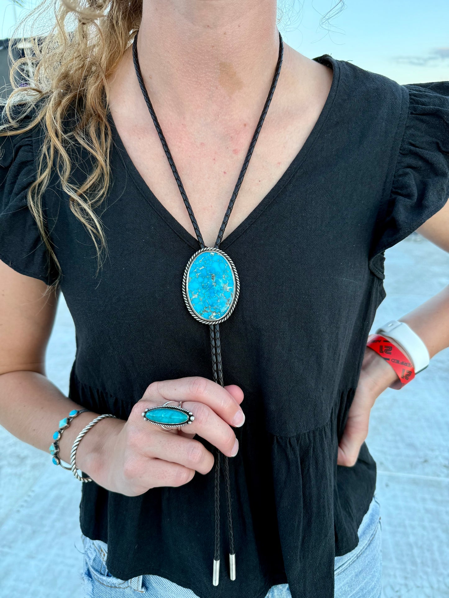 Bright Blue Kingman Turquoise Bolo Tie with dark brown leather cord and sterling silver tips