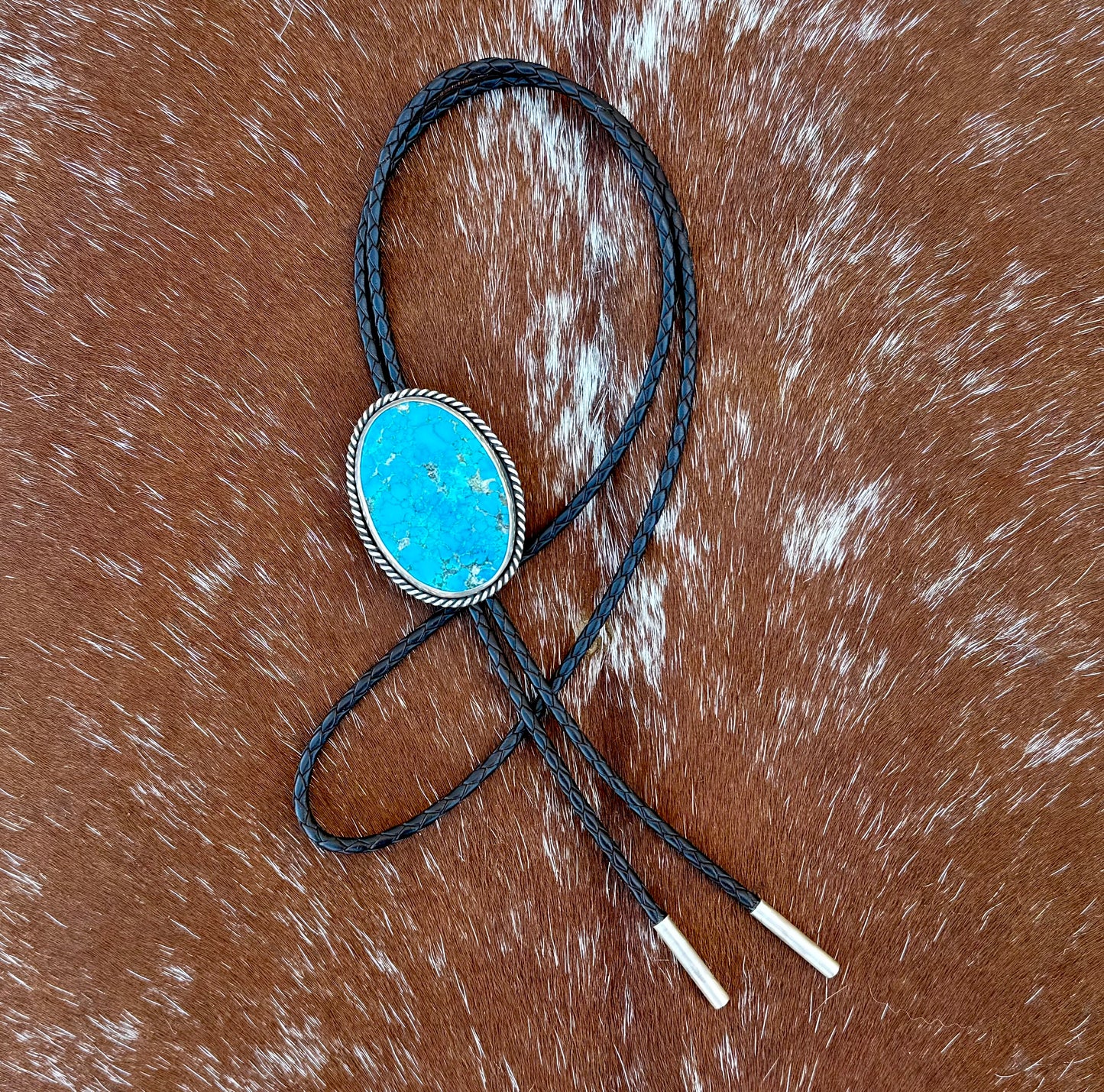 Bright Blue Kingman Turquoise Bolo Tie with dark brown leather cord and sterling silver tips