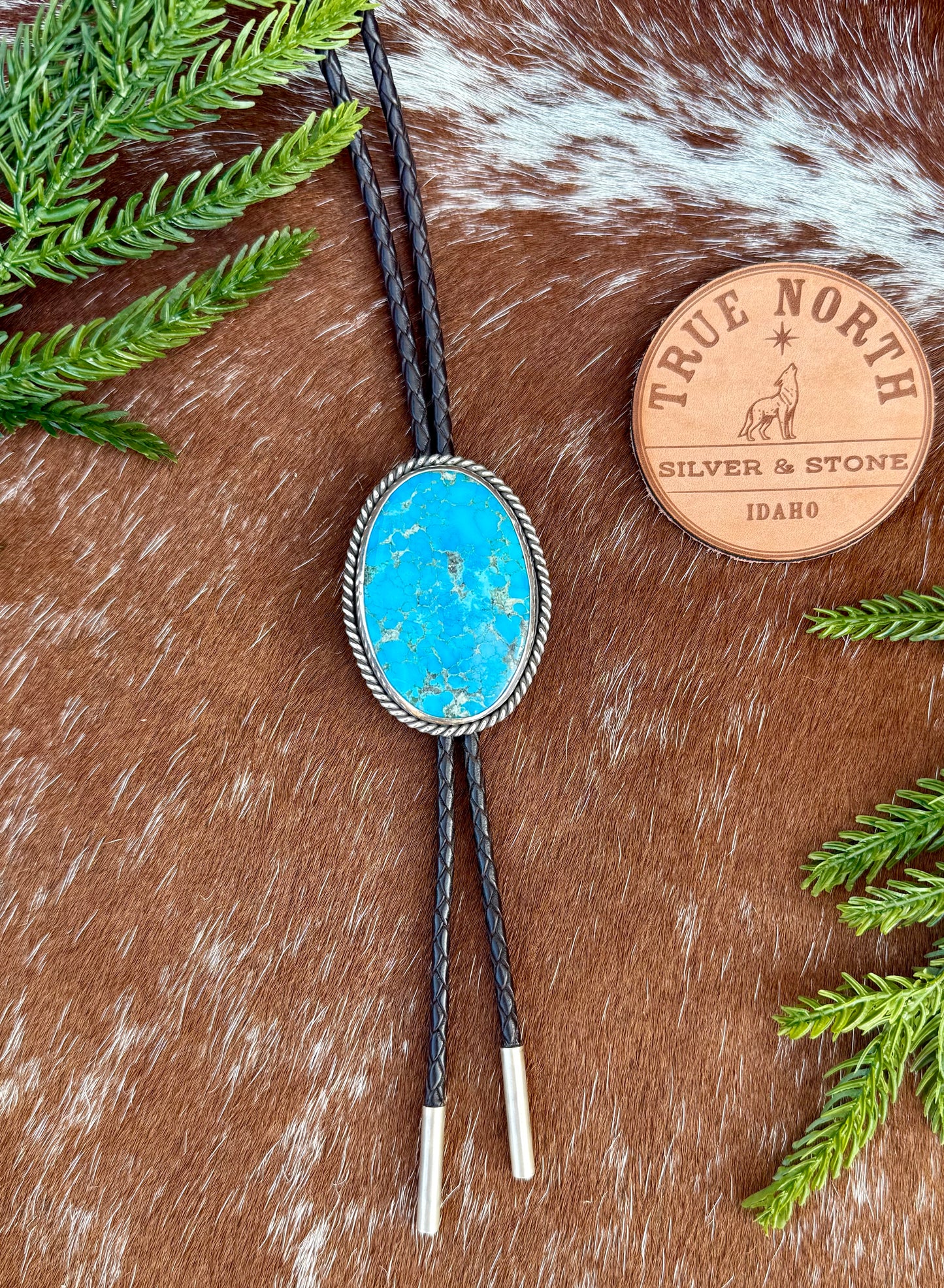 Bright Blue Kingman Turquoise Bolo Tie with dark brown leather cord and sterling silver tips