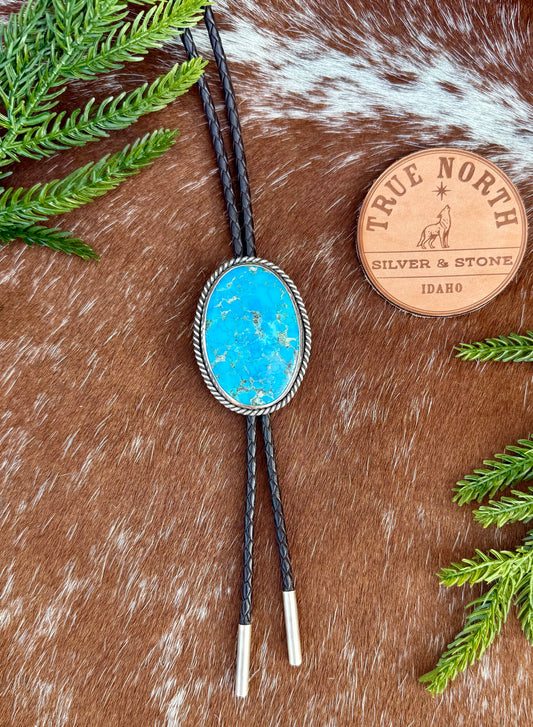 Bright Blue Kingman Turquoise Bolo Tie with dark brown leather cord and sterling silver tips