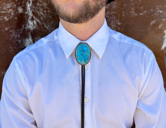 Bright Blue Kingman Turquoise Bolo Tie with dark brown leather cord and sterling silver tips