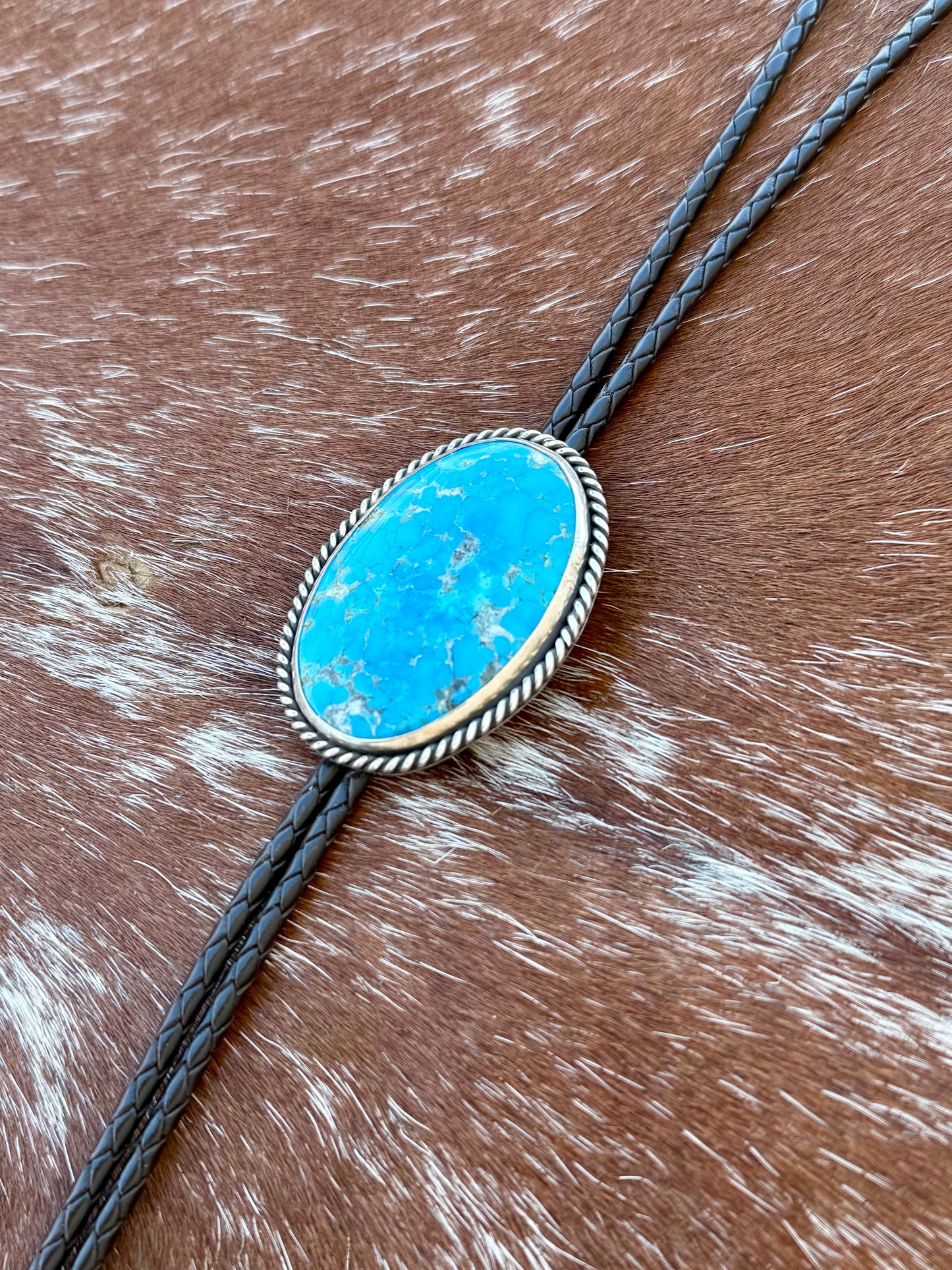 Bright Blue Kingman Turquoise Bolo Tie with dark brown leather cord and sterling silver tips